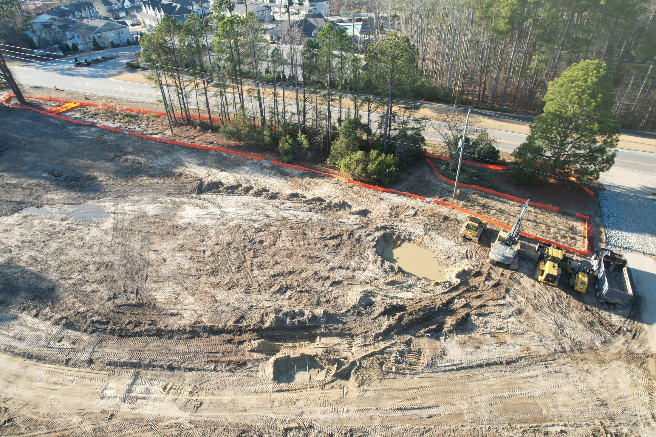Closer aerial frame of active construction equipment and grading detail